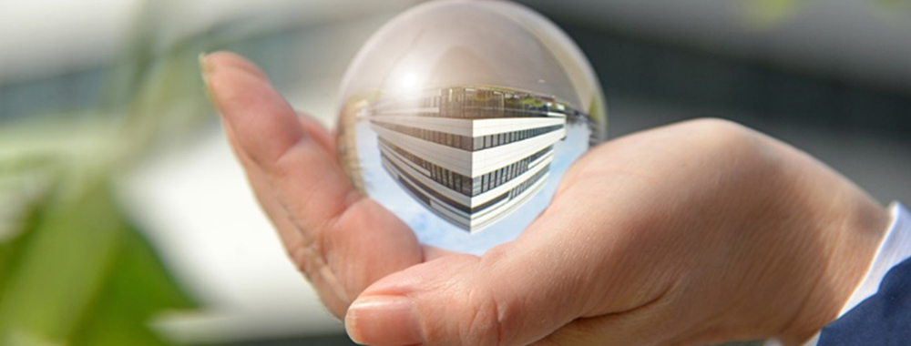 Human hand holding the Grünenthal headquarter in its hand