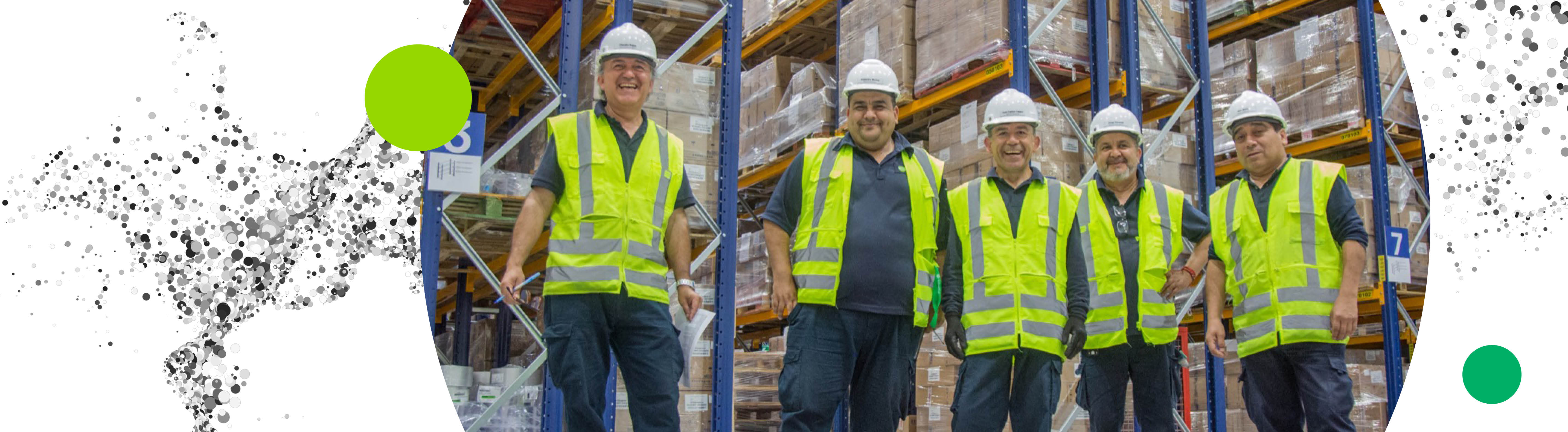 Group of smiling warehouse workers at our production site in Chile