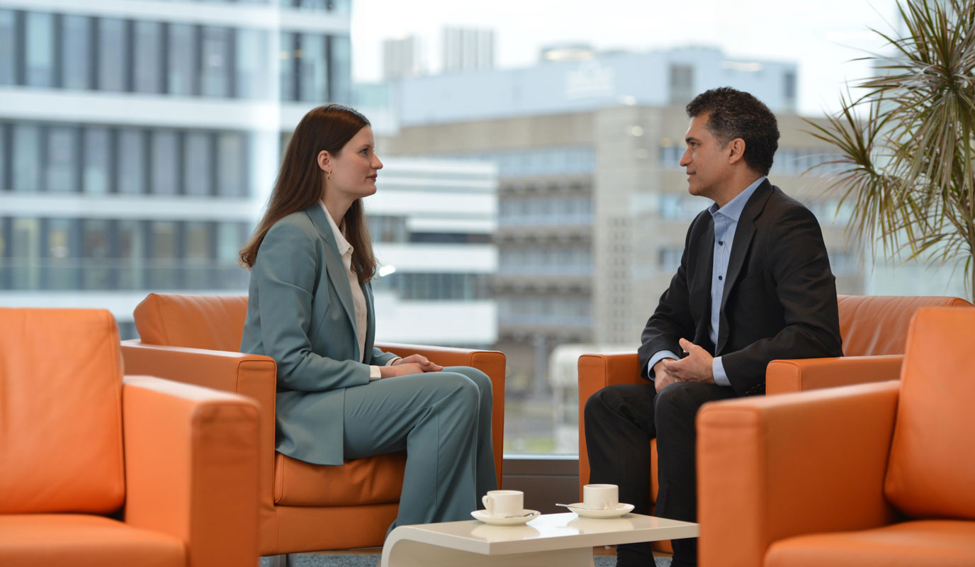 Anna Carduck and Andrew Duncan from our Investor Relations team at Grünenthal talking in a lounge area at the Grünenthal headquarters