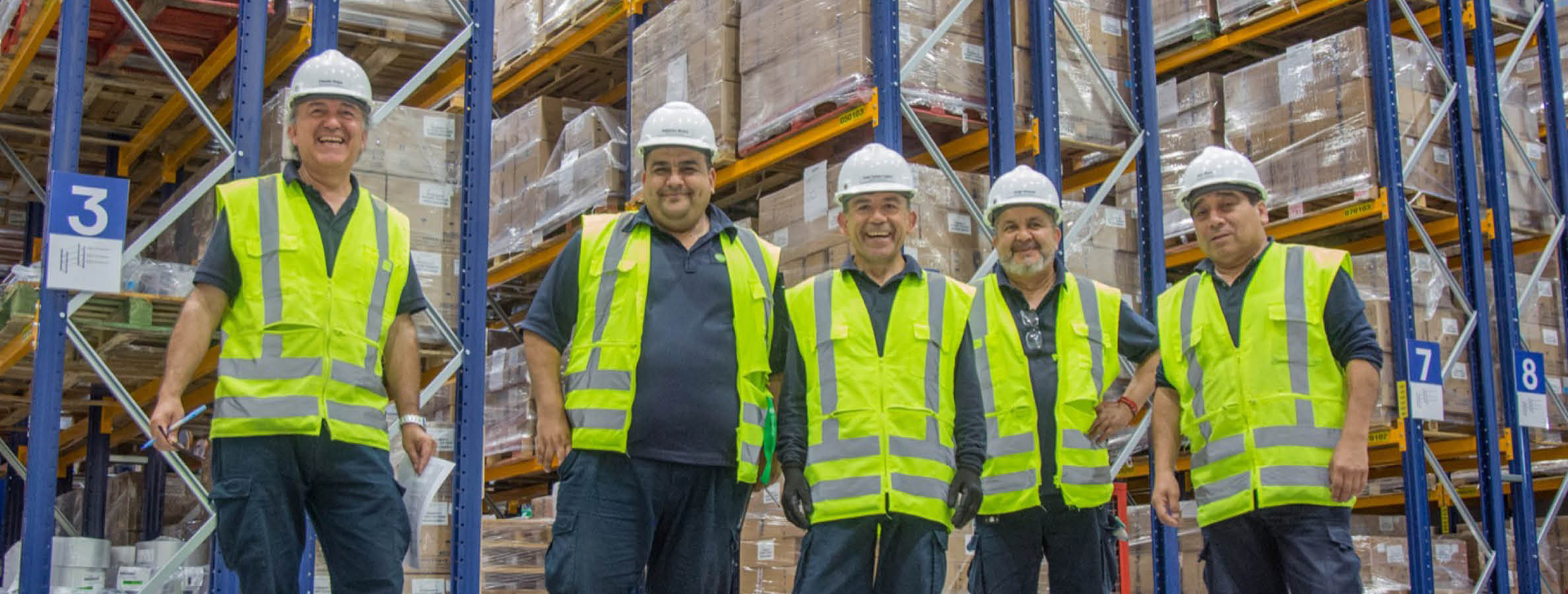 Group of smiling warehouse workers at our production site in Chile