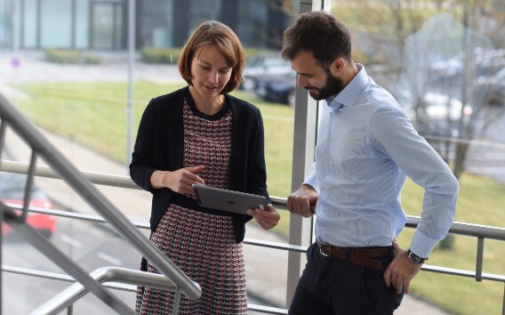 Compliance Officer speaking to colleague looking at iPad at Grünenthal Headquarters 