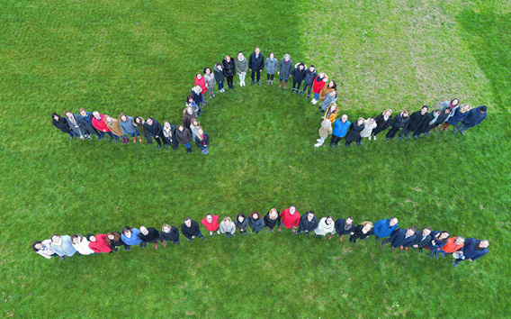 Group of people forming Grünenthal logo 