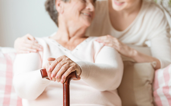 Close-up of elderly woman holding walking stick in the nursing house